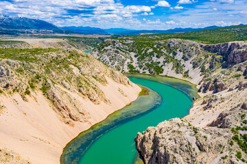 Green river with crystal clear water flowing in deep canyon. Zrmanja river canyon. Film location for Winnetou western movies. Beautiful Landscape in Croatia, EU, Europe.