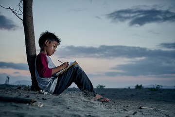 Schoolboy writing and study outdoor under the sky at night, New normal of Education concept