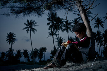 Schoolboy writing and study outdoor under the sky at night, New normal of Education concept
