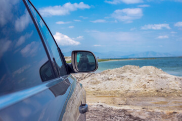 a blue car mirror in the lake