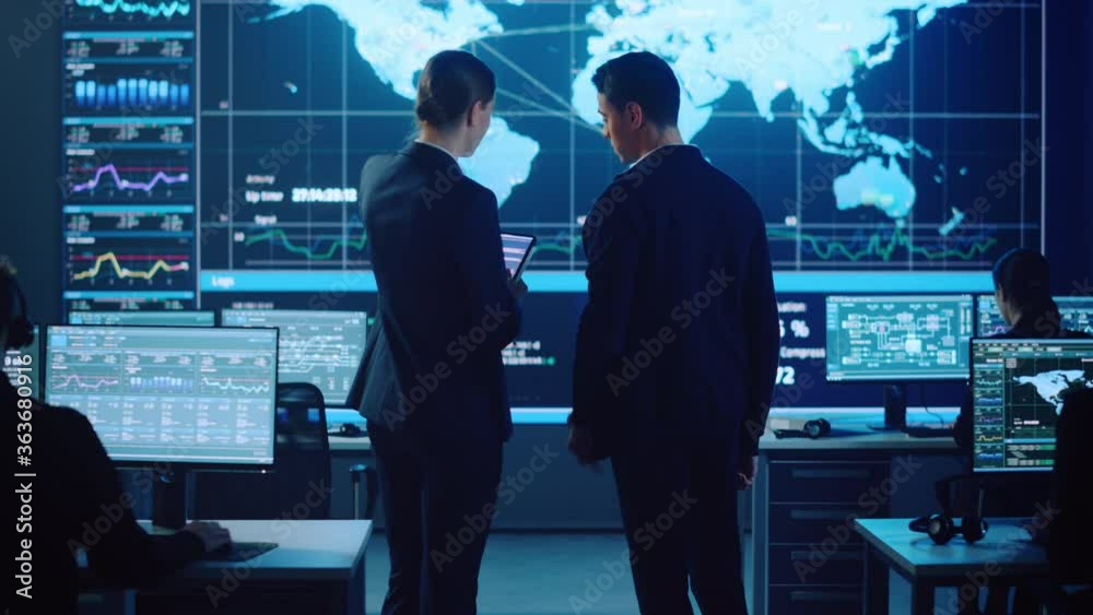 Poster Project Manager and Computer Science Engineer Talking while Using A Digital Tablet Computer. Telecommunications Company System Control and Monitoring Office Room with Working Specialists.