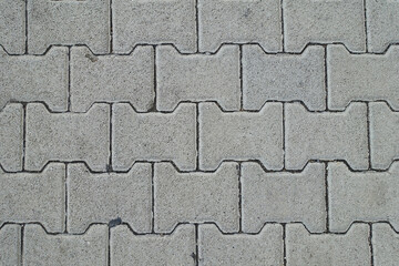 Concrete cobblestones texture and background. Close up group of solid polygon cobblestones. Part of concrete cobble sidewalk.