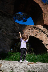 a little girl playing in the old park
