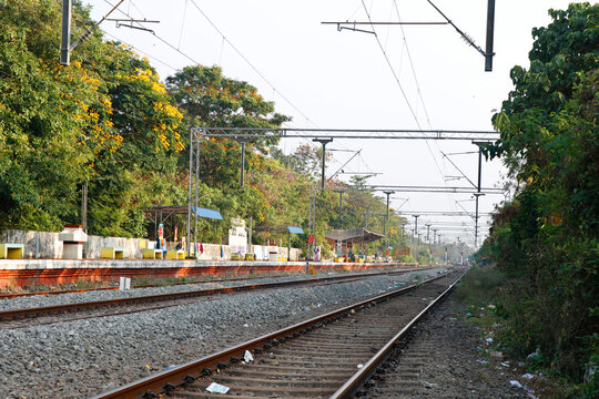 Landscape of railroad tracks in India cutting across rural countryside