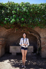 a young woman stands against the wall