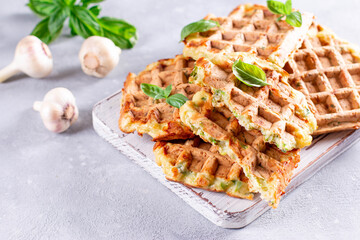 Zucchini waffle, zucchini fritters cooking on waffle maker, vegetarian zucchini waffles with basil. Copy space