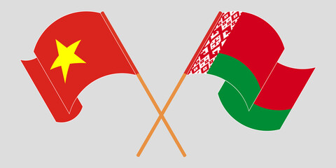 Crossed and waving flags of Belarus and Vietnam