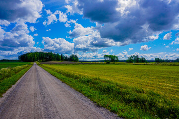 Fototapeta na wymiar Country road, finland, landscape, rural, lovely, summer, green, driving, field, clouds, wallpaper