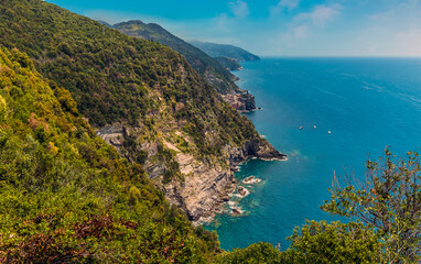 Fototapeta na wymiar A view from the Monterosso to Vernazza path towards Vernazza in the summertime
