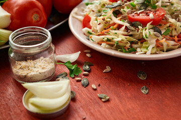 healthy food - fresh chopped vegetables on a wooden background, tomatoes and greens