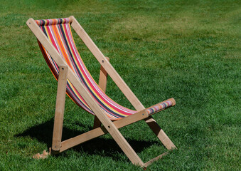 chaise longue stands on green grass
