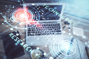 Double exposure of data drawing hologram over topview of study desk background with computer....