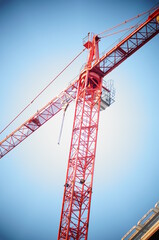The crane working on the hotel. High construction, heavy lifting jib. Work at height during construction.