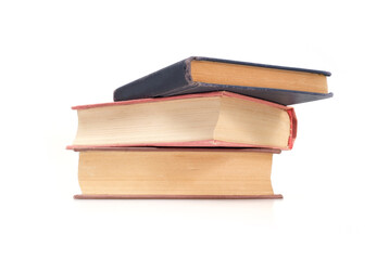 Stack of books in colour covers with white sheets isolated on a white background