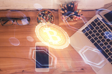 Double exposure of blockchain theme hologram over table with phone. Top view. Crypto technology concept.