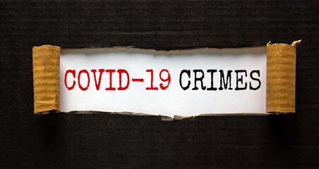 The words 'covid-19 crimes' appearing behind torn black paper. Beautiful background. Business...