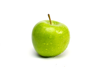 green fresh apple with water droplets on a white background.