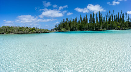 Beautiful seascape of natural swimming pool of Oro Bay, Isle of Pines, New Caledonia. aquamarine translucent water. 