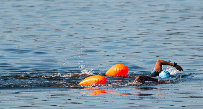 Two african american female swimmers swimming together in the bay
