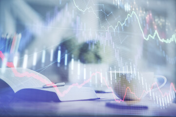 Multi exposure of forex graph drawing and desktop with coffee and items on table background. Concept of financial market trading