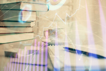 Obraz premium Double exposure of financial chart drawing and desktop with coffee and items on table background. Concept of forex market trading