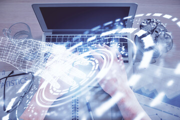 Double exposure of man's hands typing over computer keyboard and data theme hologram drawing. Top view. Technology concept.