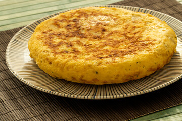 Spanish tortilla on a blue strips plate