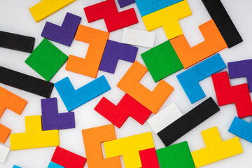Wooden intelligence puzzle pieces as colourful background