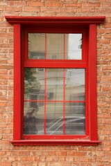 Fototapeta na wymiar beautiful Red window in a brick house