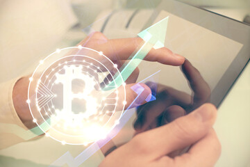 Double exposure of man's hands holding and using a phone and crypto currency blockchain theme drawing.