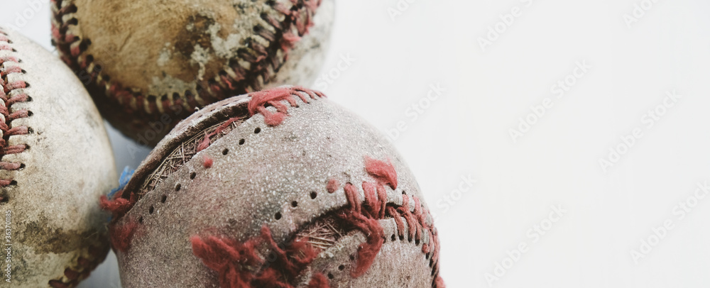 Poster old torn baseball balls close up shows used sports equipment isolated on white background.