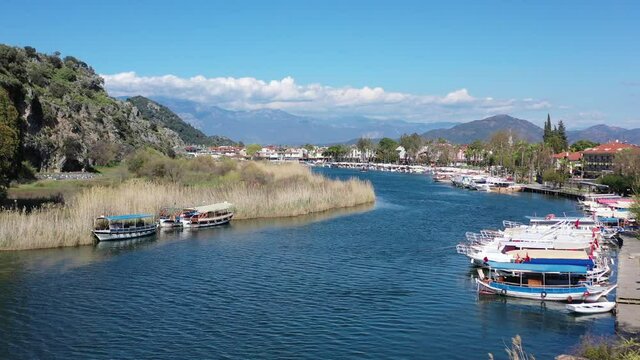 Dalyan canal view and settlement, excursion bout tour on Dalyan river valley. Dalyan is popular tourist destination in Turkey. 4K Video Aerial view from drone.