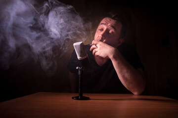 Serious reporter in television studio looking at the camera