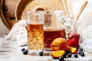 Cup of peach ice tea served with fresh peach
