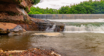 Small Waterfall Surrounded by Beautiful, Massive Red Rock Cliffs and Walls Long Exposure