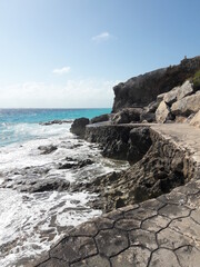 Fototapeta na wymiar Isla Mujeres South Point Cancun Mexico rocky shore blue water and crashing waves 2020