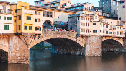 Fototapeta na wymiar Photograph of a bridge on the Arno river in italy at sunset