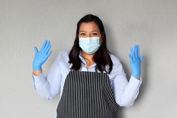 Latin woman waitress working with face masks and protective gloves, new normal by covid-19