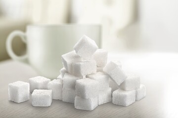 White cubes of sugar on a tea cup background
