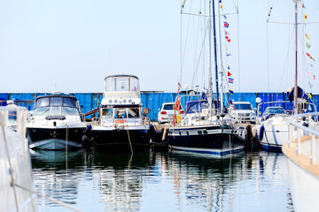 Fototapeta premium Summer, 2016 - Vladivostok, Primorsky region - Beautiful yachts and boats are in the yacht club. Snow-white yachts against the blue sky.