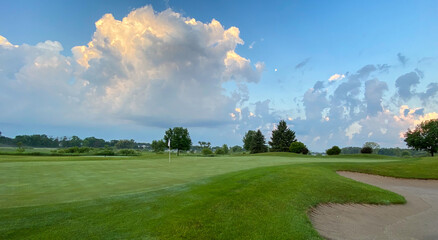 sunrise on golf course big clouds sand traps greens