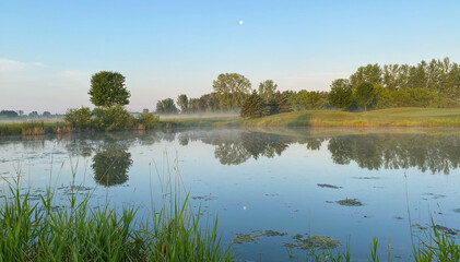Fototapeta na wymiar golf course pond marsh sunrise morning moon