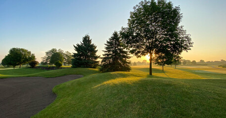 sunrise on the golf course sand trap