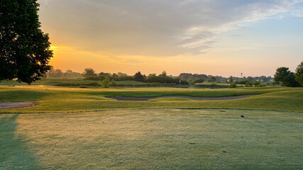 sunrise on golf course tee box green