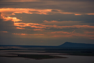 A high angle abstract background from the mountains, which can see the surrounding scenery (rivers, roads, communities, trees) and the evening twilight from the beautiful sky.