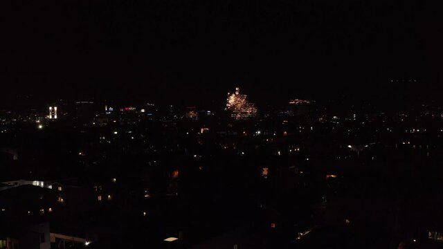 Aerial descending shot of illegal fireworks around Hollywood skyline on 4th of July. 4K