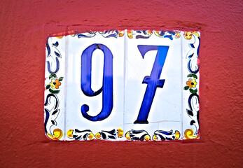Number 97, ninety-seven, blue digits and burgundy red background.