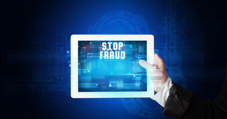 Young business person working on tablet and shows the digital sign: STOP FRAUD
