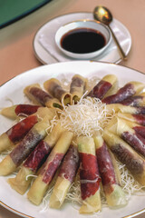 Peking Duck - Chinese peking duck wrapped in pancakes with cucumber, spring onions and hoisin sauce.