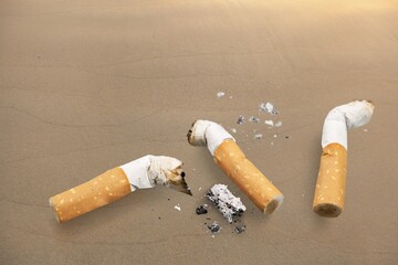 Cigarette butts on the desk. Bad habit concept